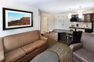 a living room with a couch and a table at Candlewood Suites Tyler, an IHG Hotel in Tyler