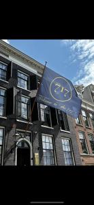 a blue flag flying in front of a building at Hotel 717 in Amsterdam