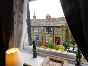 a window with a view of a building at No 11 Rooms in Haworth