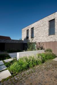 a brick building with plants in front of it at Nuit Blanche in Oud-Heverlee