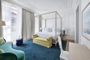 a bedroom with a white bed and a yellow chair at One Shot Palácio Cedofeita in Porto +61 photos