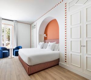 a bedroom with a white bed and an open door at One Shot Palácio Cedofeita in Porto +75 photos