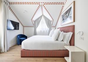 a bedroom with a large bed and a blue chair at One Shot Palácio Cedofeita in Porto