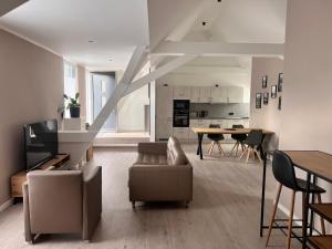 a living room with a couch and a table at New Nomads Ferienwohnung am See in Zossen