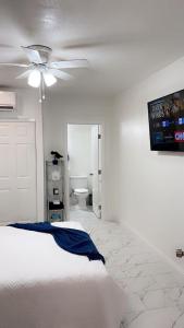 a bedroom with a bed and a ceiling fan at Guest House , 5 min away from LAS Airport. in Las Vegas +14 photos