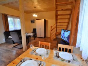 a dining room with a table and a living room at Cottages near the sea for 2 people Ustronie Morskie in Ustronie Morskie