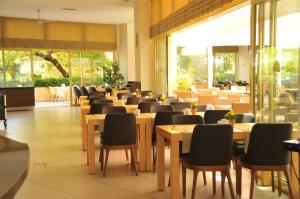 a row of tables and chairs in a restaurant at Golden Lotus Hotel in Kemer