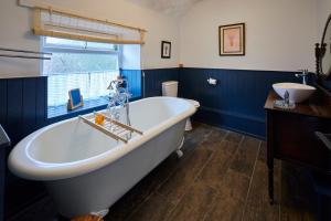 a bathroom with a large tub and a sink at Host & Stay - Stone Row in Skinningrove