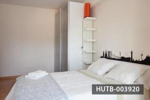 sypialnia z białym łóżkiem z panoramą miasta w obiekcie Splash w Barcelonie