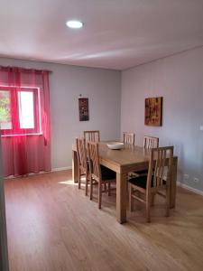 a dining room with a wooden table and chairs at Fernandes Apartments in Ponte de Lima