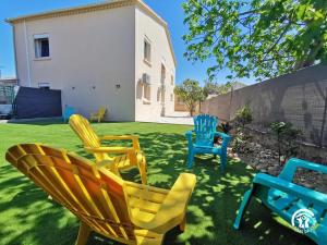 a group of chairs sitting in a yard at DOUMO in Agde