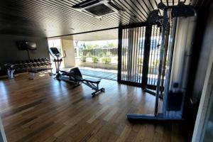 a gym with two treadmills on a hard wood floor at Precioso apartamento en moderno edificio in Montevideo