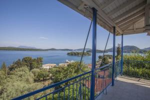 a view of the water from the balcony of a house at Gianna Studios in Nydri