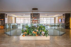 een grote tentoonstelling van bloemen in een lobby bij 5 Star Hotel Concept Apartments with Spa and Sport Center in Esenyurt