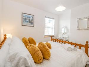 a bedroom with two beds with pillows on them at Seashell Cottage in Lowestoft
