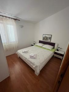 Postel nebo postele na pokoji v ubytování Apartments and Rooms Markovski