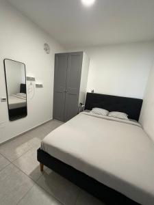 a bedroom with a large bed and a mirror at Lincoln Design Apartments in Jerusalem