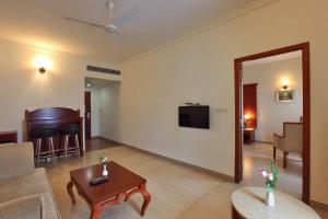 a living room with a couch and a table at Cochin Palace in Cochin