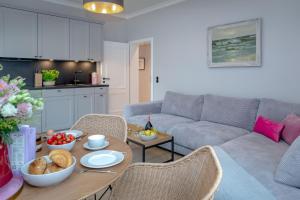 a living room with a couch and a table with food on it at Steuerbord in Westerland (Sylt)