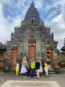 a group of people standing in front of a building at SunwuKong Guest House in Ubud