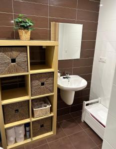 een badkamer met een wastafel, een toilet en een spiegel bij Arnela Reinante in Barreiros