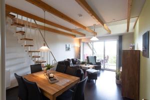 a living room with a wooden table and chairs at LM7-15 - Ferienwohnung Typ AB in Schottwarden