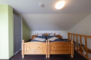 a bedroom with a wooden bed in a attic at LM7-15 - Ferienwohnung Typ AB in Schottwarden