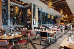 a restaurant with tables and chairs in a room at Sheraton Bursa Hotel in Bursa