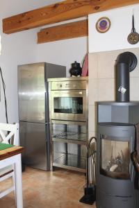 a kitchen with a stainless steel refrigerator and an oven at Altes Waschhaus in Putbus