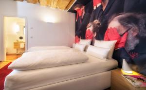 A bed or beds in a room at Small Luxury Hotel Goldgasse