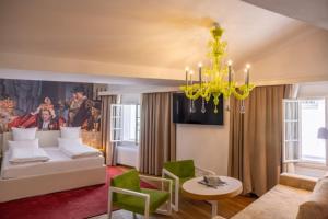A bed or beds in a room at Small Luxury Hotel Goldgasse