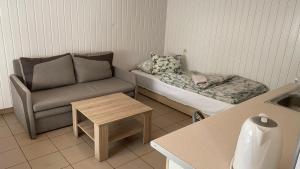 a small living room with a couch and a table at Kemping Obora in Racibórz