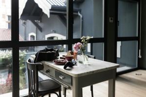 a table with a vase of flowers on it at Bucolico Monza in Monza
