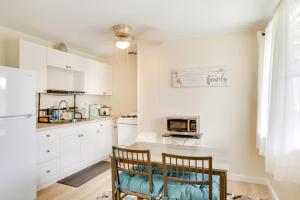 a kitchen with white cabinets and a table and chairs at Quaint Hilo Vacation Rental with Community Pool! in Hilo