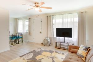 a living room with a couch and a flat screen tv at Quaint Hilo Vacation Rental with Community Pool! in Hilo