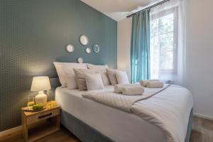 a bedroom with a large white bed with a window at Apartament24 Stare Miasto Wrocław in Wrocław