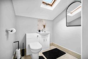 a white bathroom with a toilet and a sink at Showcase Estates in Birmingham