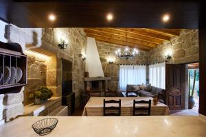 a living room with a stone wall at CASA DO COMBRO in Ponteareas
