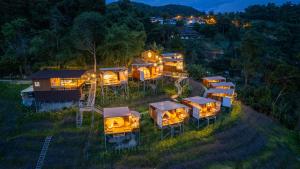an aerial view of a group of luxury cabins at night at ภูสกาย โฮมสเตย์ in Mon Jam