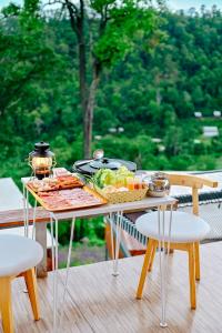 a table with a tray of food on a deck at ภูสกาย โฮมสเตย์ in Mon Jam