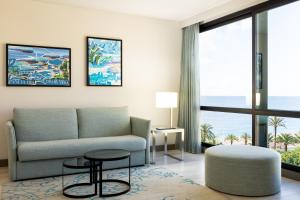 un soggiorno con divano e tavolo di AC Hotel by Marriott Nice a Nizza