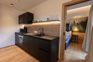 a kitchen with a sink and a counter top at Landhaus Riepler in Wagrain