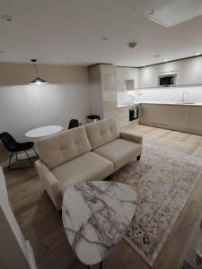 a living room with a couch and a table at Central Leeds modern 1bed apartment in Leeds