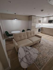 a living room with a couch and a table at Central Leeds modern 1bed apartment in Leeds