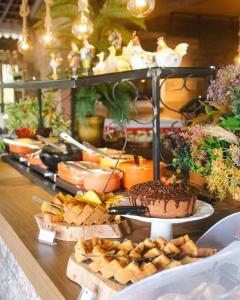 a buffet with a chocolate cake and other food at Eco Resort Pedra Bonita in Santo Estêvão