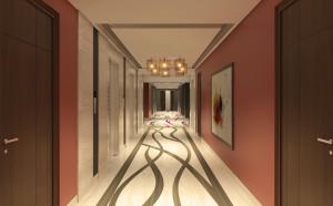 a hallway with orange walls and a hallway with shadows on the floor at Flora Al Barsha Hotel At The Mall in Dubai