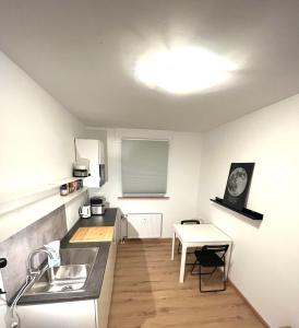 a kitchen with a sink and a table at X-Hain Kiezwohnung in Berlin