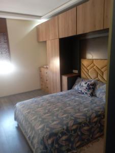 sypialnia z dużym łóżkiem z drewnianym zagłówkiem w obiekcie حرية w mieście Aïn Chock
