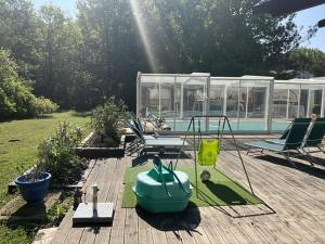 a backyard with a swimming pool with chairs and a pool at Maison sous les chênes in Le Gua +2 photos
