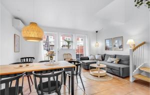a living room with a couch and a table at Stunning Home In Blvand With 2 Bedrooms, Sauna And Wifi in Blåvand